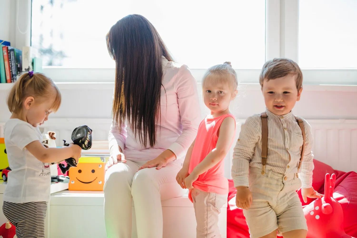 A caregiver leading a group activity with young children